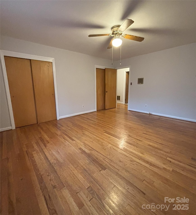 3367 Marshall Wolfe Rd, Kings Mountain, NC 28086 - unfurnished bedroom featuring ceiling fan, multiple closets, and light wood-type flooring