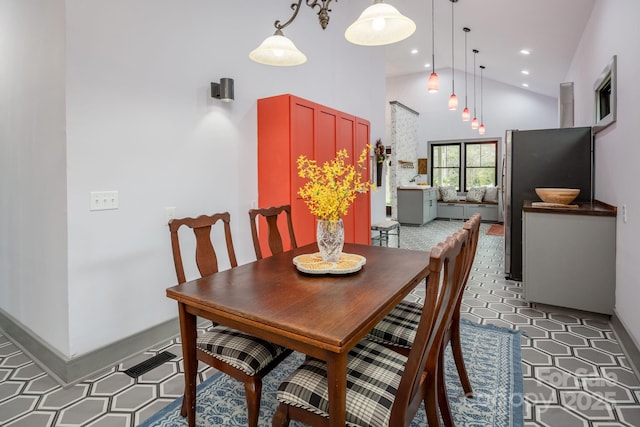 dining room with high vaulted ceiling