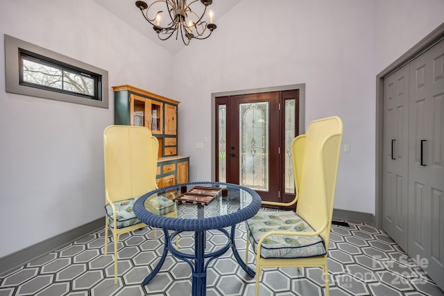 living area with plenty of natural light, a chandelier, and high vaulted ceiling