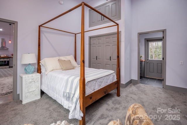 bedroom with light carpet, a closet, and ensuite bathroom