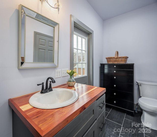 bathroom featuring vanity and toilet