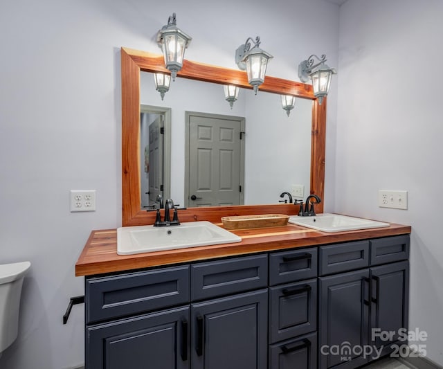 bathroom featuring vanity and toilet