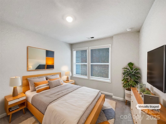 bedroom with carpet, visible vents, and baseboards