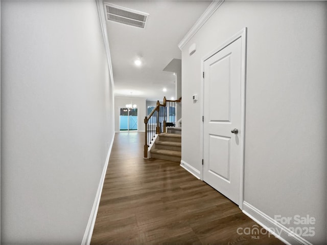 corridor with dark wood finished floors, visible vents, stairway, a chandelier, and baseboards