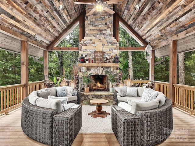 deck with ceiling fan and an outdoor living space with a fireplace