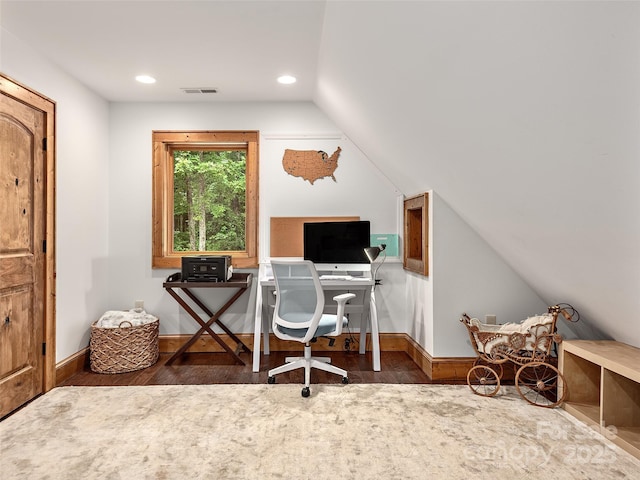 home office featuring vaulted ceiling and dark hardwood / wood-style floors