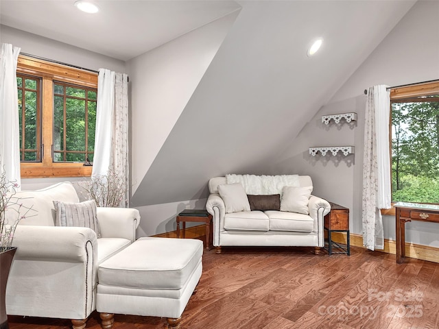 sitting room with hardwood / wood-style flooring and vaulted ceiling