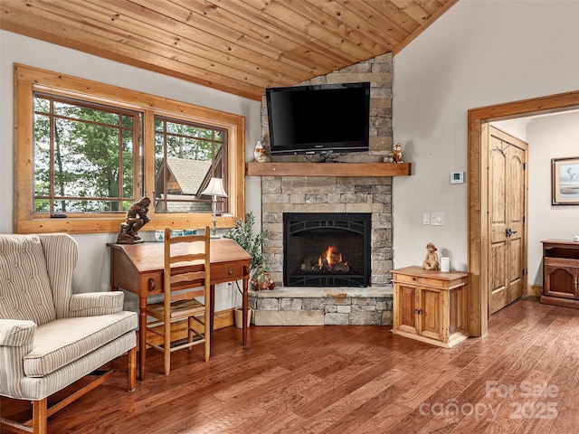 living area with hardwood / wood-style floors, wood ceiling, a fireplace, and vaulted ceiling