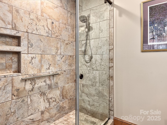 bathroom with tiled shower