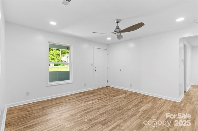 spare room featuring ceiling fan and light hardwood / wood-style flooring