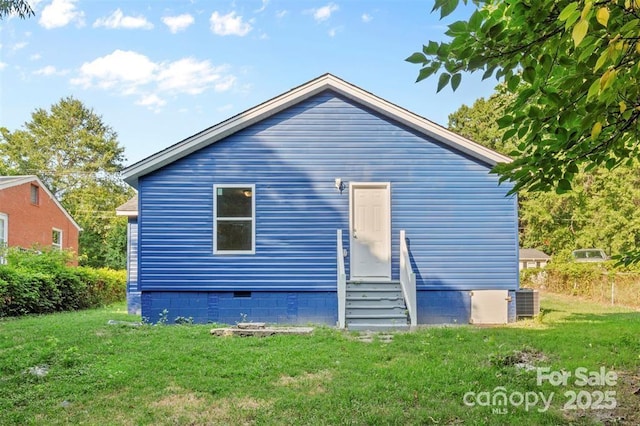 rear view of property with a yard