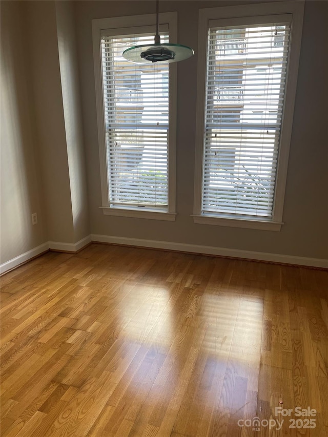 empty room with light wood-style floors and baseboards