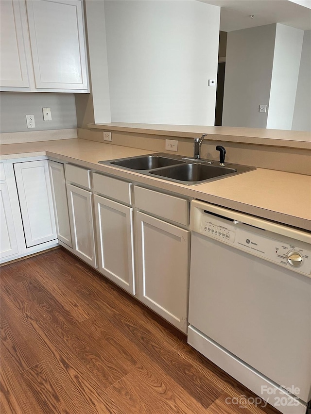 kitchen with dishwasher, light countertops, a sink, and white cabinets