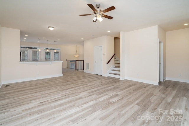 unfurnished living room with baseboards, recessed lighting, light wood-style floors, and visible vents