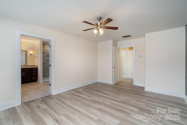 unfurnished bedroom with baseboards, visible vents, a ceiling fan, light wood-style floors, and ensuite bathroom