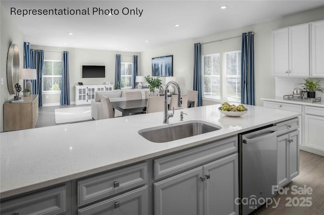 1809 Ab Moore Jr Dr Unit 3238, Indian Trail, NC 28079 - kitchen featuring stainless steel dishwasher, a sink, light stone countertops, white cabinets, and recessed lighting