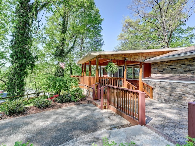 wooden terrace with a porch and a patio area