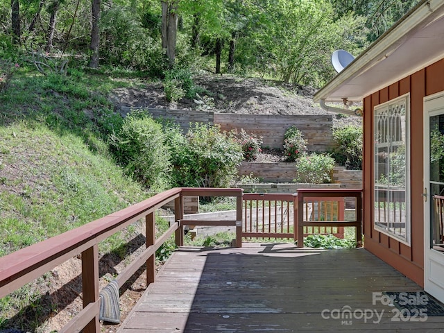 wooden terrace featuring fence