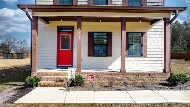 entrance to property featuring covered porch