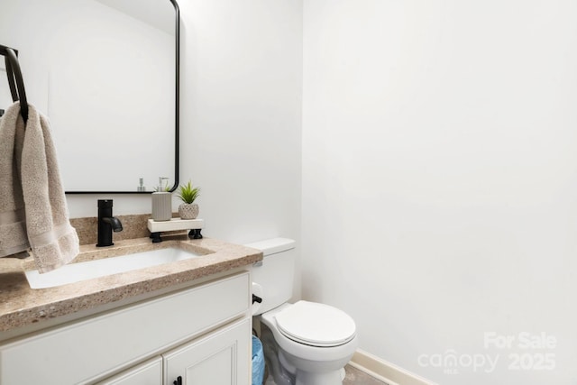 half bath with vanity and toilet