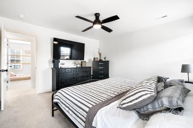 bedroom featuring carpet floors, a ceiling fan, visible vents, and multiple windows