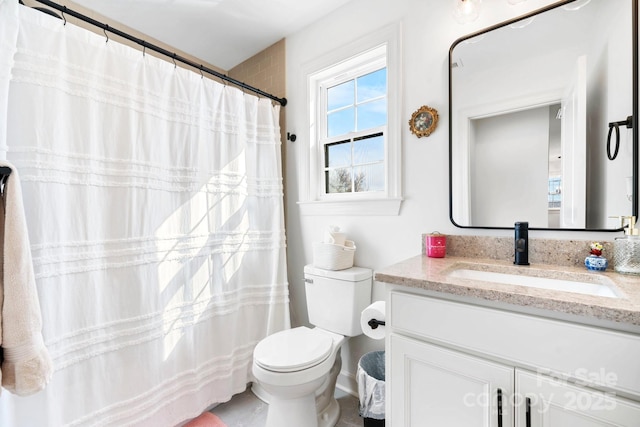 bathroom featuring toilet and vanity