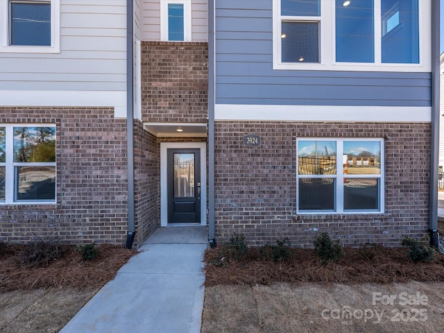 entrance to property with brick siding