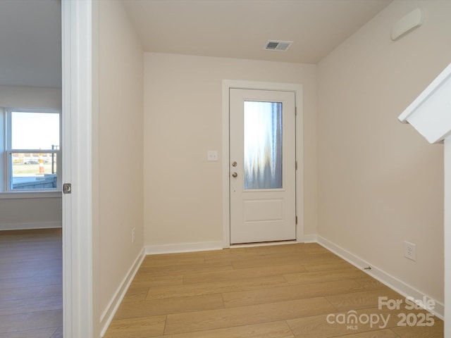 entryway with visible vents, light wood-style flooring, and baseboards