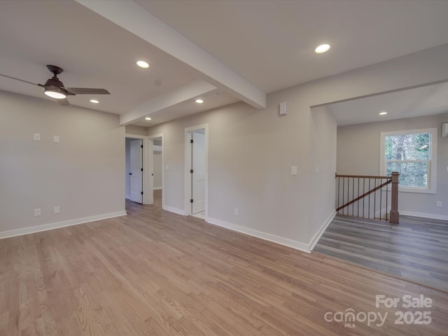 unfurnished room featuring beamed ceiling, ceiling fan, and light hardwood / wood-style flooring