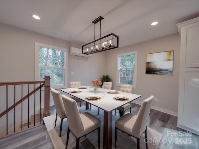 dining room with hardwood / wood-style flooring and a wall mounted AC