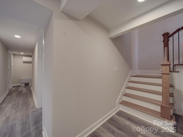 stairway with hardwood / wood-style flooring