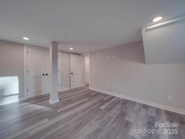 basement with light hardwood / wood-style floors