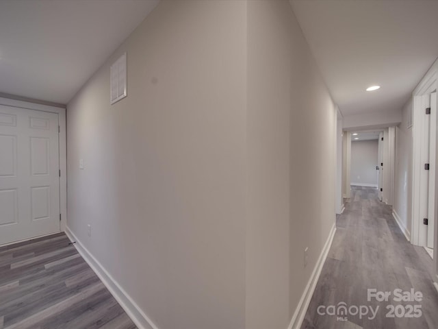 corridor with hardwood / wood-style floors