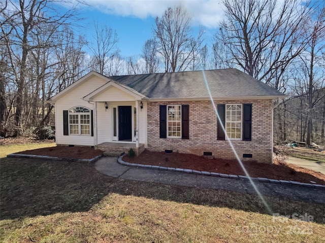 ranch-style home with roof with shingles, brick siding, crawl space, and a front lawn