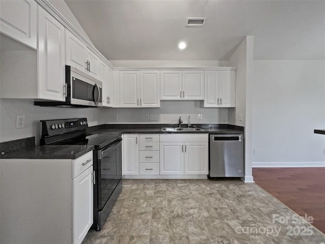 kitchen featuring stainless steel appliances, white cabinetry, and sink