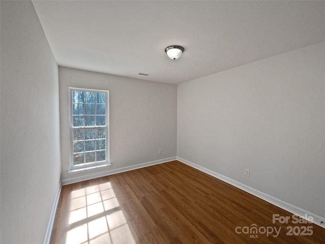 spare room featuring hardwood / wood-style flooring