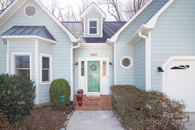 property entrance with a garage and roof with shingles