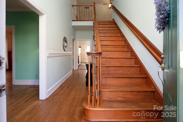 stairs featuring baseboards and wood finished floors