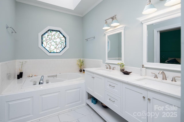 bathroom featuring ornamental molding, marble finish floor, a sink, and a bath