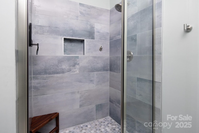 bathroom with a shower stall