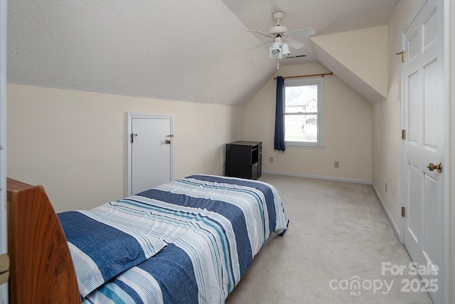 bedroom with ceiling fan, a textured ceiling, lofted ceiling, light carpet, and baseboards