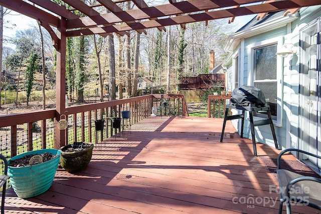 deck with fence, area for grilling, and a pergola