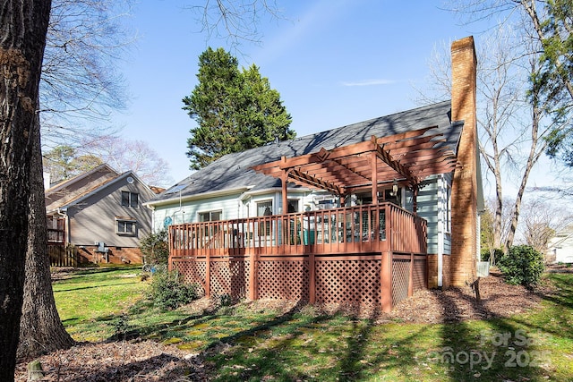 back of property featuring a chimney, a yard, a deck, and a pergola