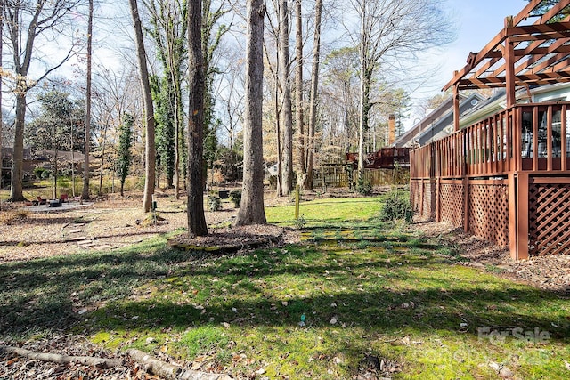 view of yard with a wooden deck and a pergola