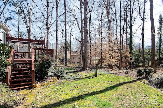 view of yard featuring stairs and a wooden deck