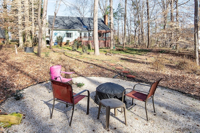 view of patio featuring an outdoor fire pit and a wooden deck