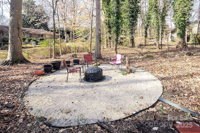 view of yard with an outdoor fire pit and a patio area