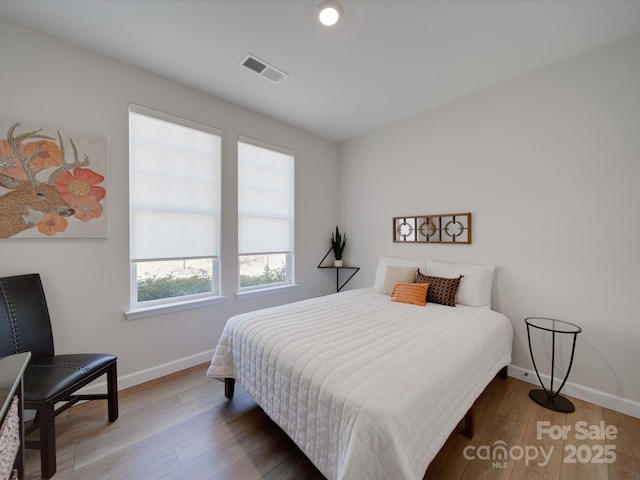 bedroom with wood-type flooring