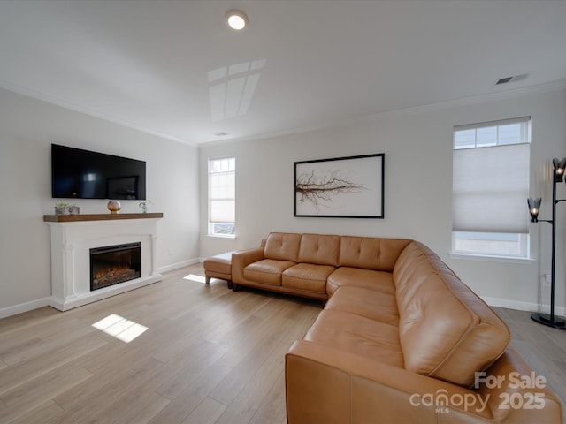 living room featuring light hardwood / wood-style flooring and crown molding