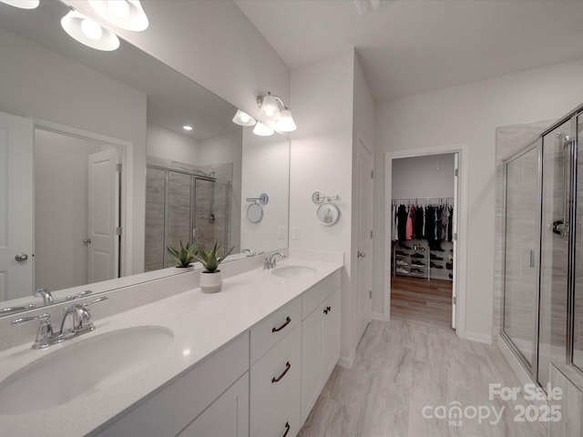 bathroom featuring vanity and a shower with door